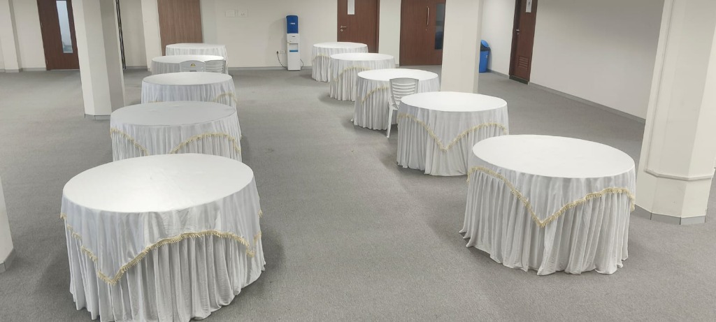 Round Table Setup with Elegant White Tablecloths